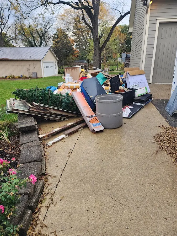 Dumpster being loaded with debris for Estate Cleanout Dumpster Rental in Albertville